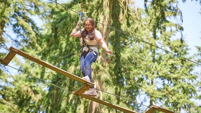 Image of girl taking on treetop challenge web landscape 1920x1080