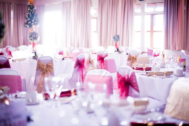 Christmas themed tables decorated in the Safari Lodge with pink and gold ribbons and Christmas trees